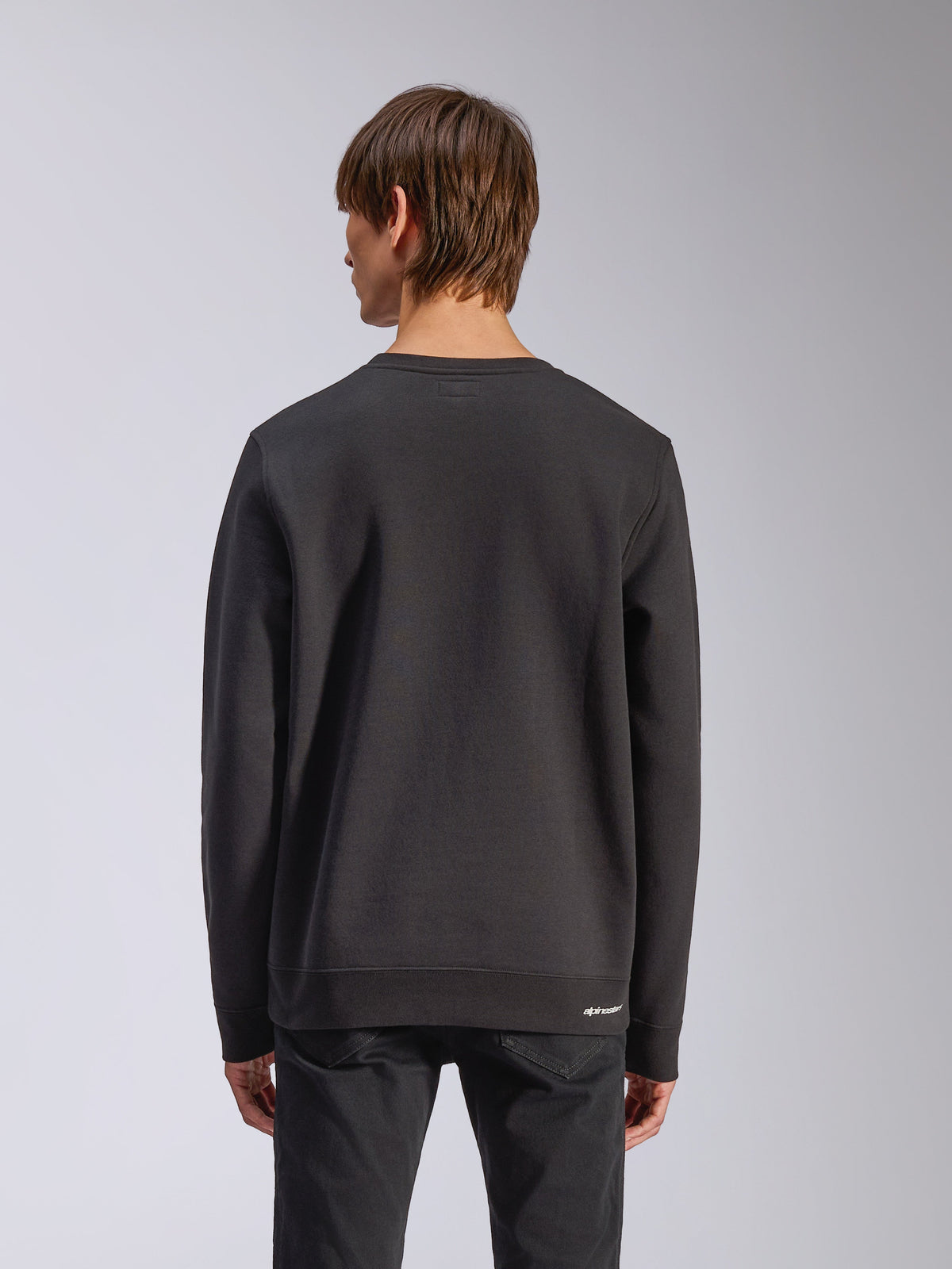 Alpinestars Positive Crew, Pullover Sweatshirt, Black, Back View, featuring ribbed cuffs and hem with a small white logo at the hip, casual motorsport-inspired design