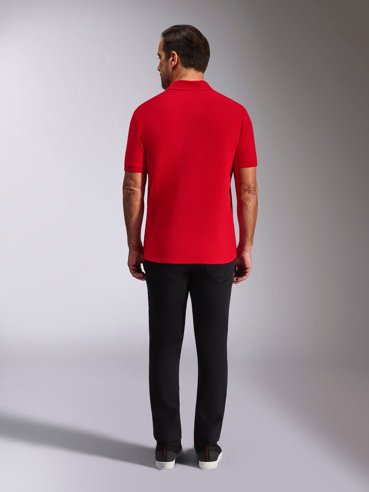 Alpinestars Endeavor Classic Polo, Red Pique Polo Shirt, back view, worn with black pants, casual motorsport streetwear featuring ribbed collar and sleeve cuffs