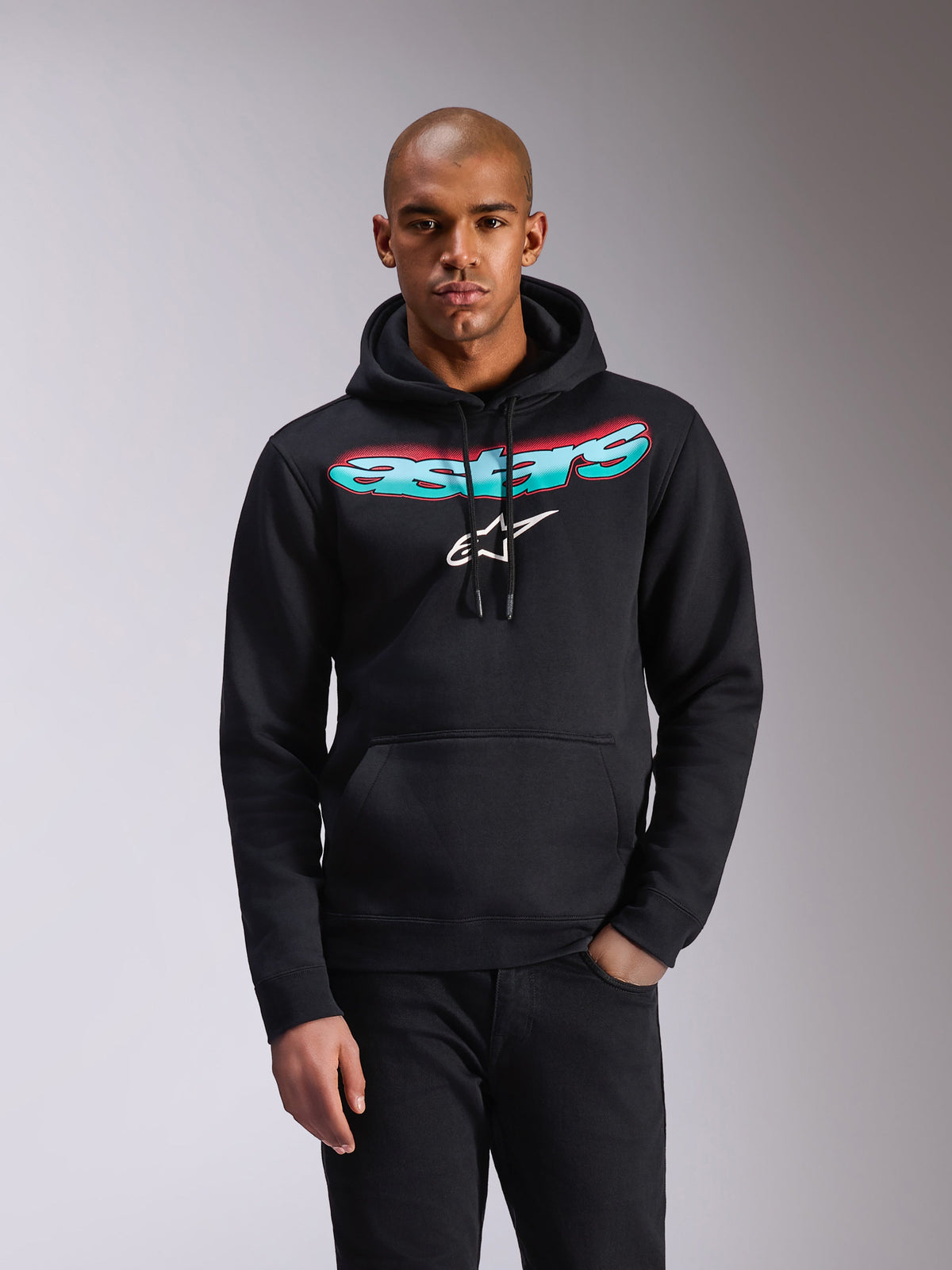 Alpinestars Ellipsoid Hoodie, schwarzer Fleece-Kapuzenpullover, Astars-Schriftzug mit Farbverlauf in Blaugrün und Pink und weißes Stern-Logo auf der Brust, Kapuze mit Kordelzug, Kängurutasche, lässige Sportbekleidung