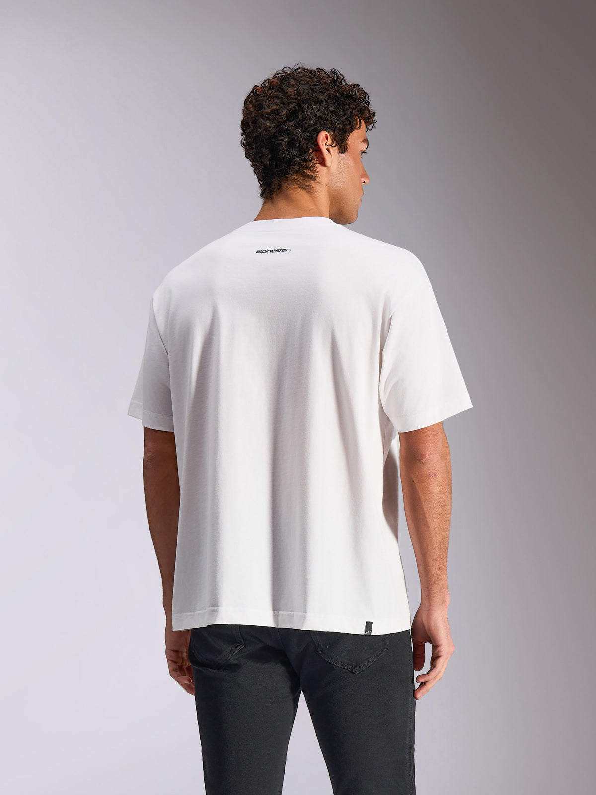 Alpinestars Focused Oversized CSF Tee, Short Sleeve T-Shirt, White, back view on model showing small black Alpinestars word logo below the neckline, oversized relaxed fit, casual streetwear
