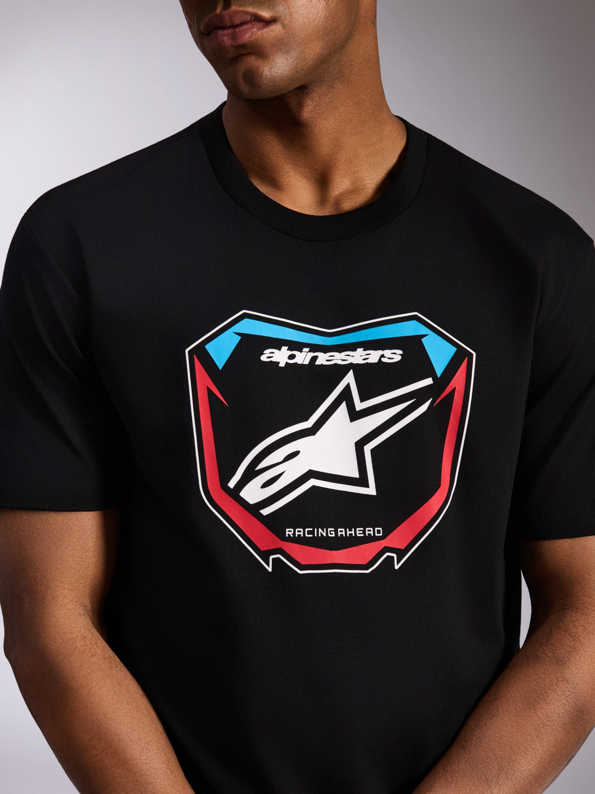 Alpinestars Plate CSF Tee, Short Sleeve T-Shirt, Black, front motocross plate graphic with white Astars logo, red and blue accents, and 'RACING AHEAD' text, casual motorsport-inspired streetwear