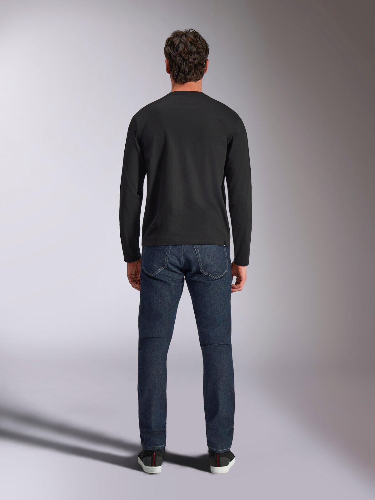 Alpinestars Trackside CSF Tee, Long Sleeve T-Shirt, Black, back view on a model wearing dark blue denim jeans, casual motorsport streetwear