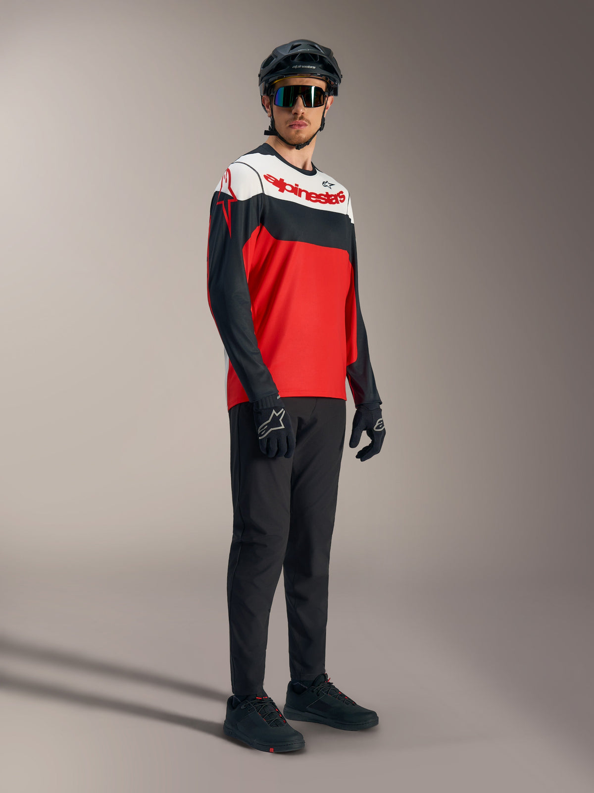 A-Dura Race Long Sleeve Jersey in red, black, and white with bold logos, styled with professional mountain biking gear.