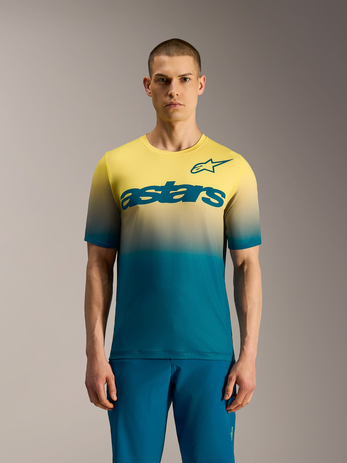 A-Dura ASTARS Jersey 2.0, Kurzarm-MTB-Trikot mit Farbverlauf von Blaugrün zu Gelb-Fluo und markantem Brust-Logo.