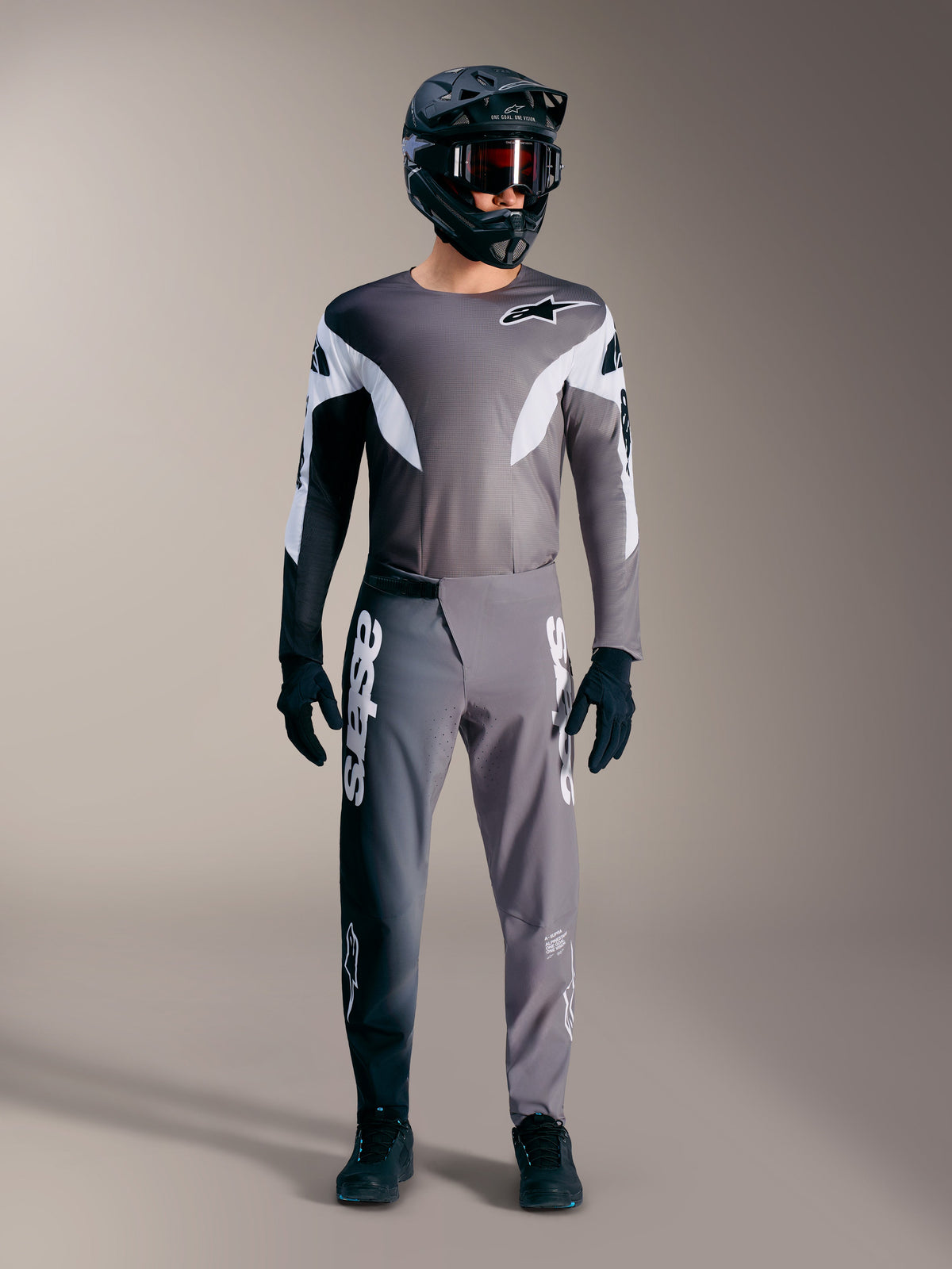 Alpinestars A-Supra Elite MTB gear in faded gray, featuring performance jersey and pants with bold white logos.