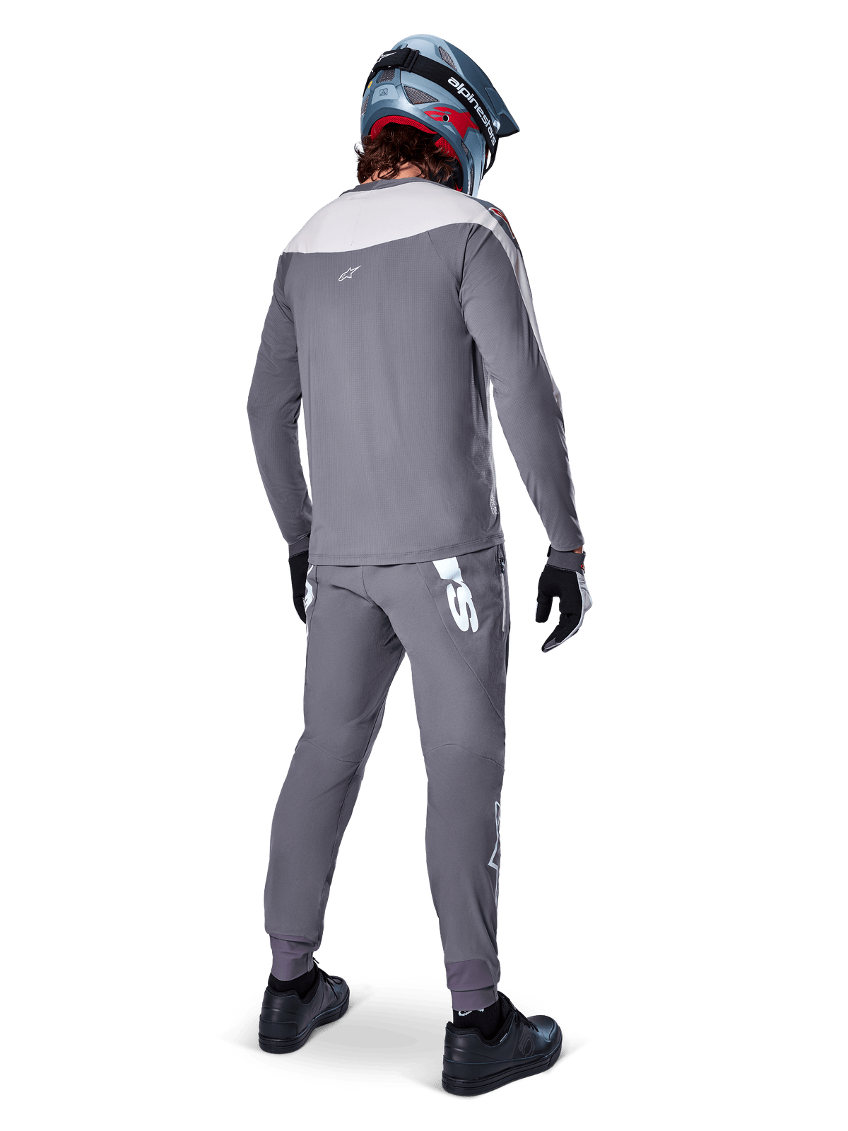 Alpinestars A-Supra Race Jersey, Long Sleeve MTB Jersey, Dark Gray with light gray shoulder panel, back view worn with matching pants, blue and red full-face helmet, black gloves and shoes, racing-inspired performance cycling gear