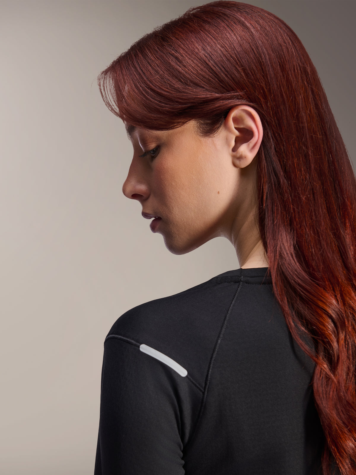 Alpinestars Stella A-Dura Thermal Jersey, Women's Long-Sleeve MTB Jersey, Black, close-up side view highlighting the reflective silver strip on the shoulder, technical insulated fabric for mountain biking