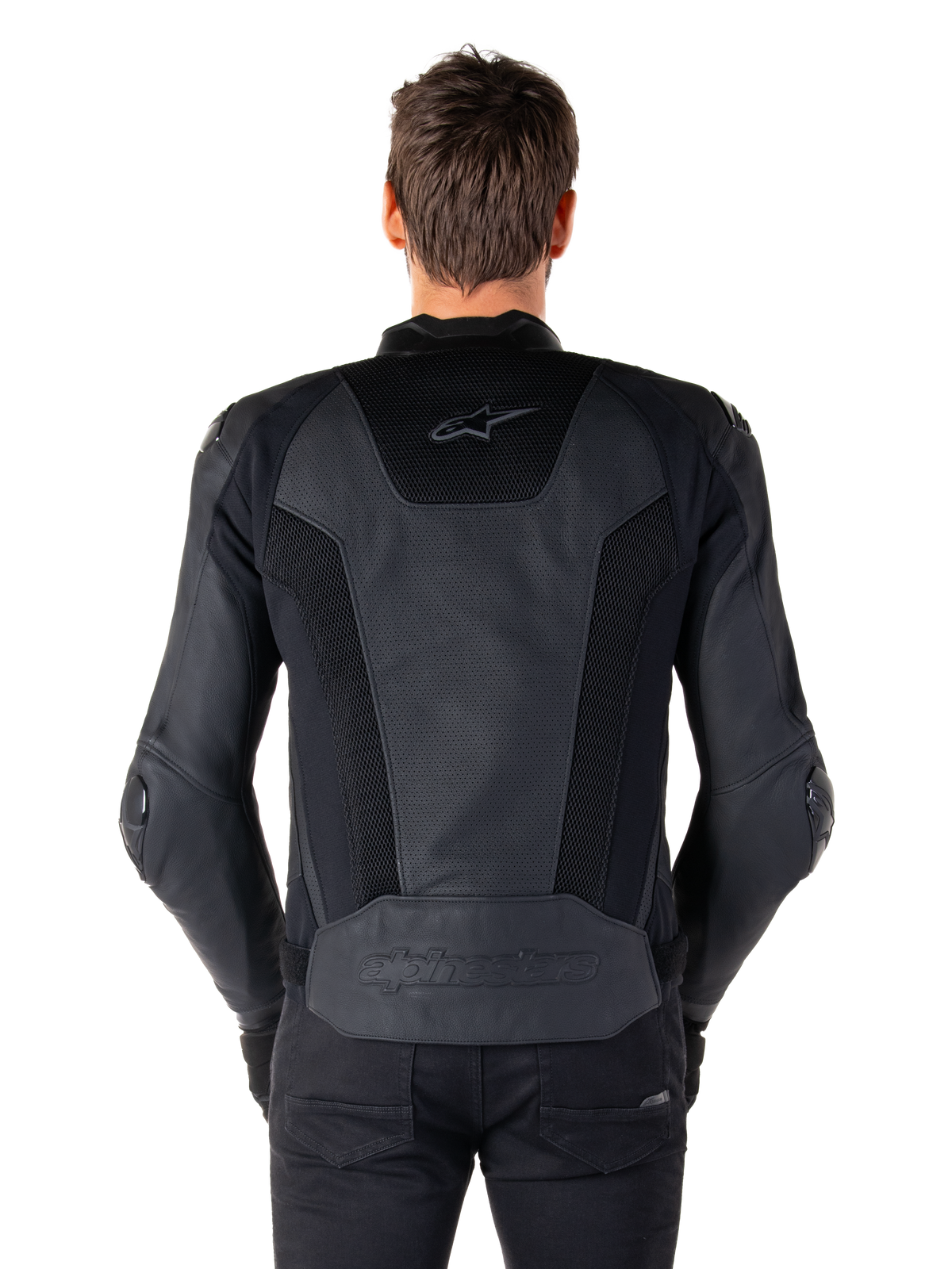Rear view of a model wearing the Alpinestars Missile V3 Airflow Leather Jacket in Black, showing extensive perforated panels and mesh inserts on the back for ventilation, with embossed branding on the lower back.