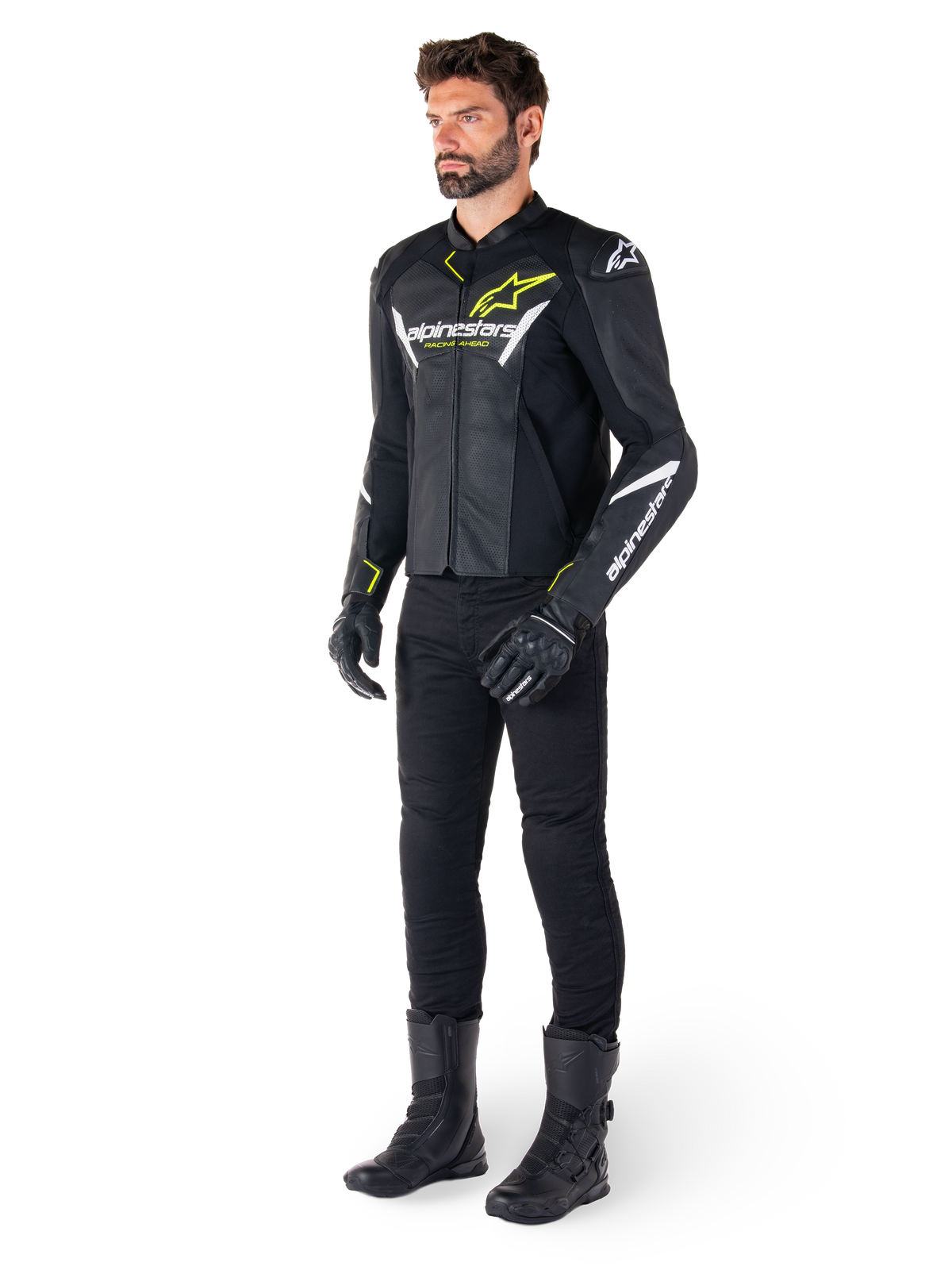 Male rider wearing the Alpinestars Faster V3 Airflow Leather Jacket in Black White and Yellow Fluo, paired with black motorcycle pants and boots, featuring perforated leather panels, white logo details, and neon yellow accents, professional sport riding gear