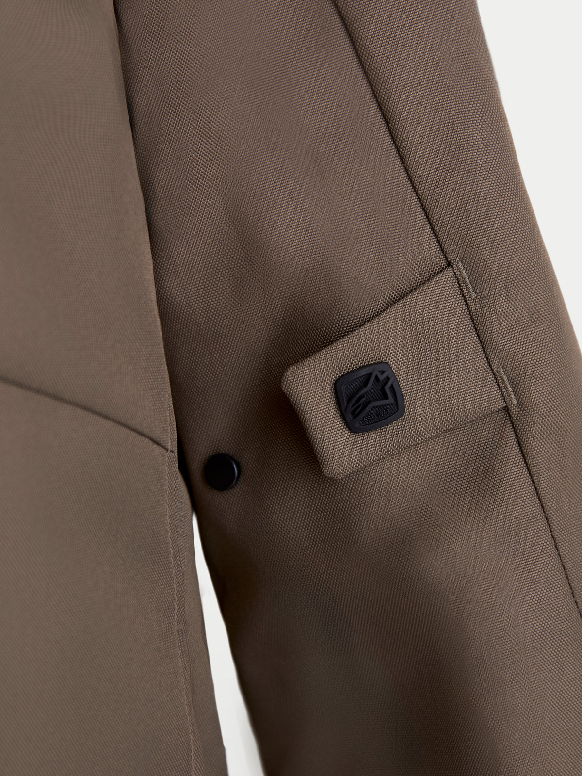 Alpinestars C-1 Waterproof Jacket, urban motorcycle textile jacket detail view showing walnut brown 450D polyfabric construction, snap adjustment system, and black Alpinestars logo badge