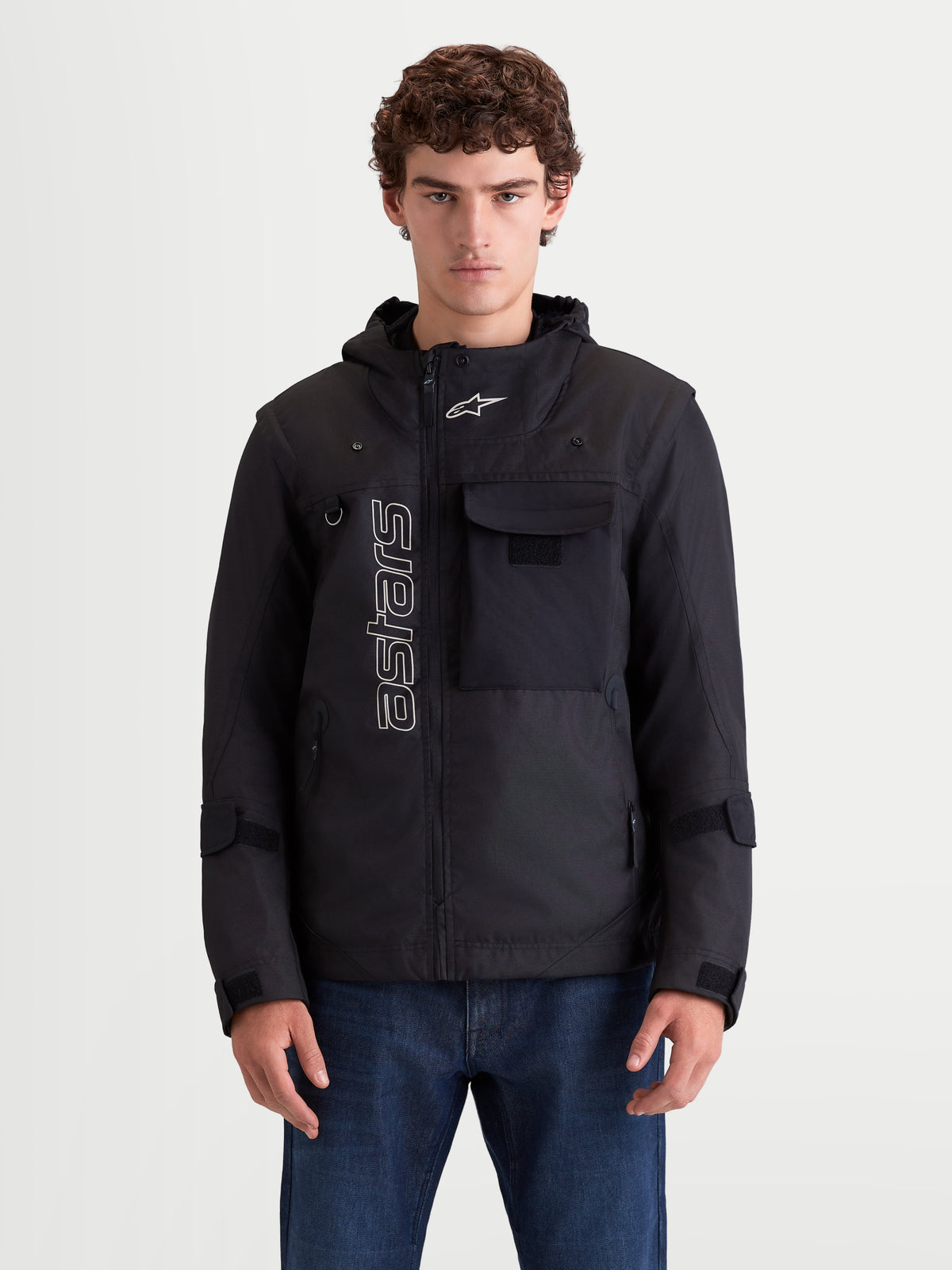 Alpinestars Morfex Parka WP Jacke, urbane Motorrad-Textiljacke für Herren in Schwarz, Vorderansicht an einem Model mit Parka-Design, integrierter Kapuze und Brusttasche