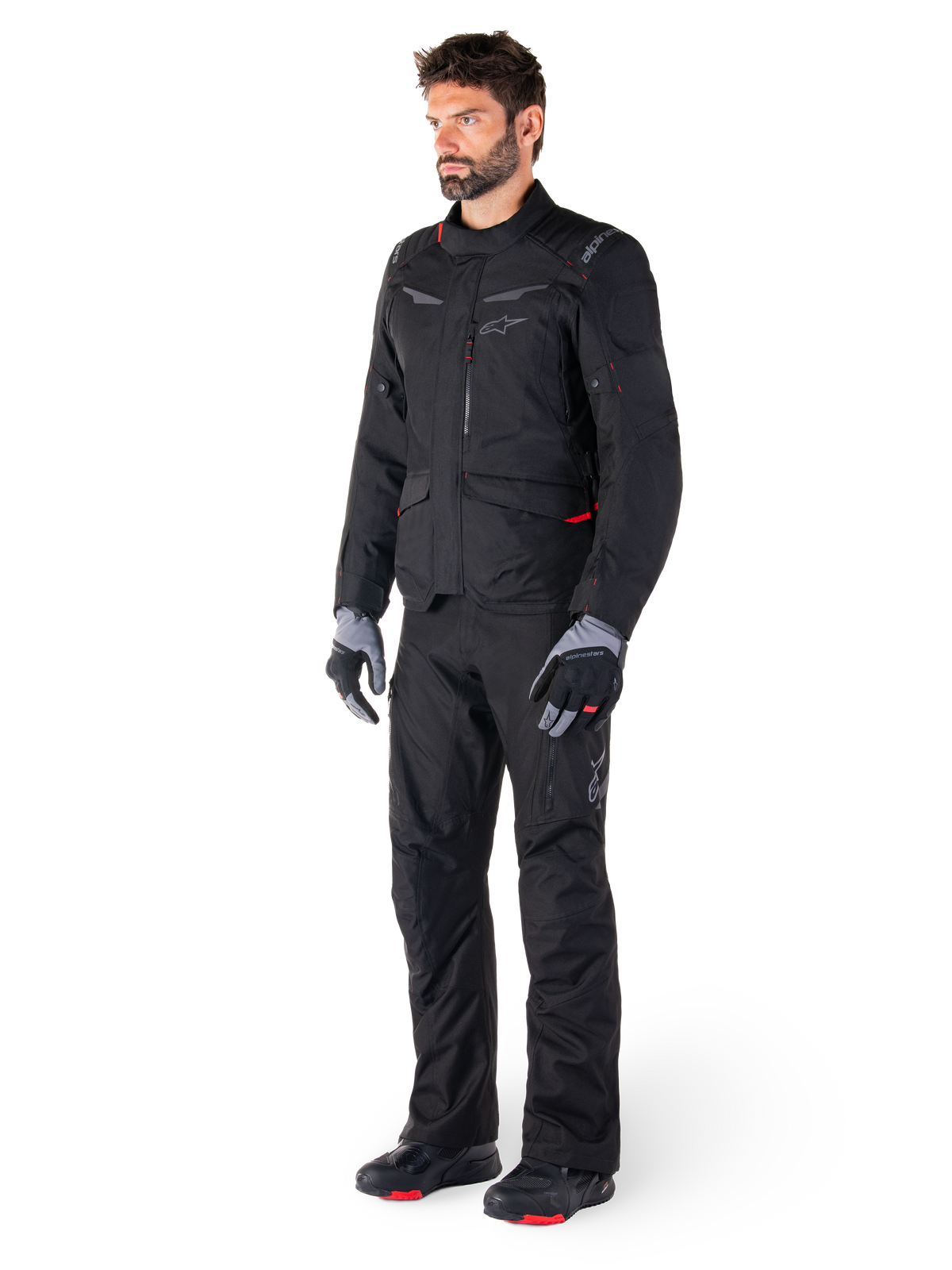 Alpinestars ST-1 Waterproof Jacket, Black, adventure touring jacket with red accents, worn with matching black pants, gloves and boots, full body view of rider in complete all-weather gear set