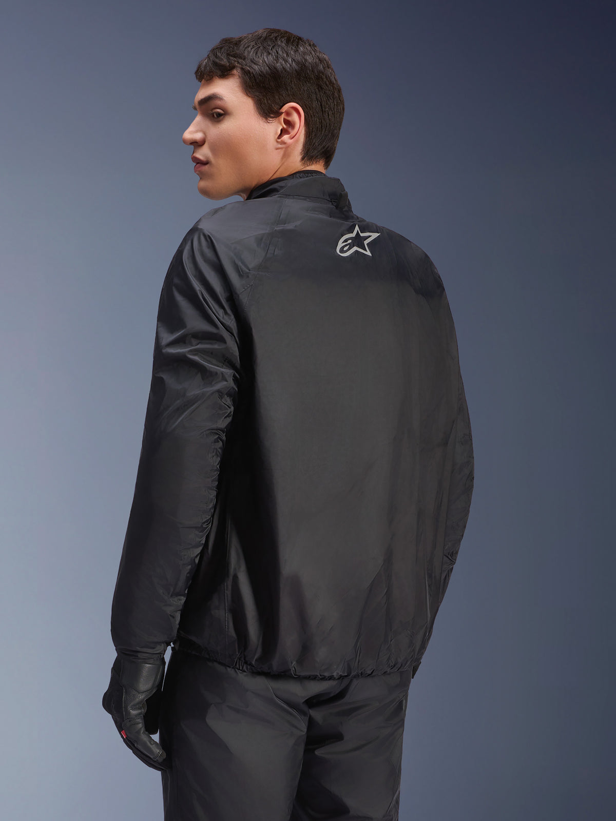 Alpinestars Andes Air Drystar® Jacket, detachable waterproof membrane in Black, back view on a male model, featuring a small white Alpinestars logo on the upper back, paired with black riding gloves