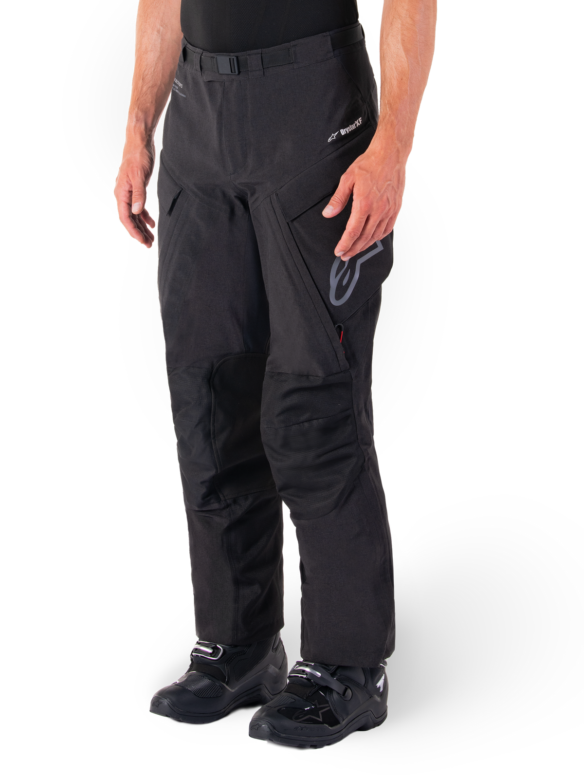 Alpinestars Hyde XT Drystar® Pants, Adventure Touring Motorcycle Pants, Black, worn with black boots, featuring laminated Drystar®XF membrane branding, reinforced knee panels, and zippered cargo pockets.