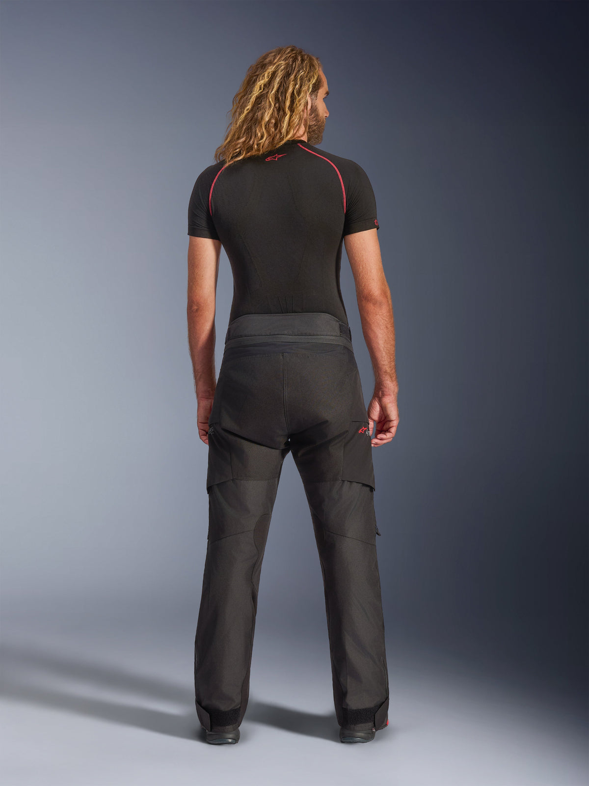 Alpinestars Andes V4 Drystar® Pants, Motorcycle Adventure Pants, Black, rear view worn with a black compression shirt, featuring reinforced textile construction and technical design for all-weather touring.