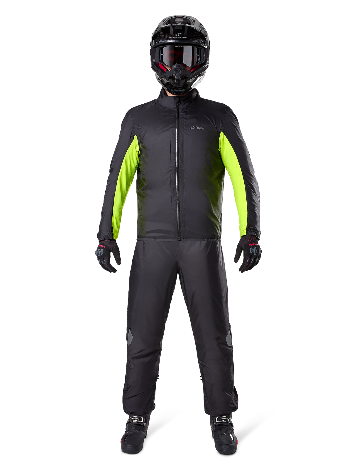 Alpinestars Bogota Pro Drystar 3 Seasons Pants, Black, worn by a motorcycle rider in a full adventure outfit including a black and neon yellow waterproof jacket, black helmet, and riding boots, designed for all-weather touring performance.