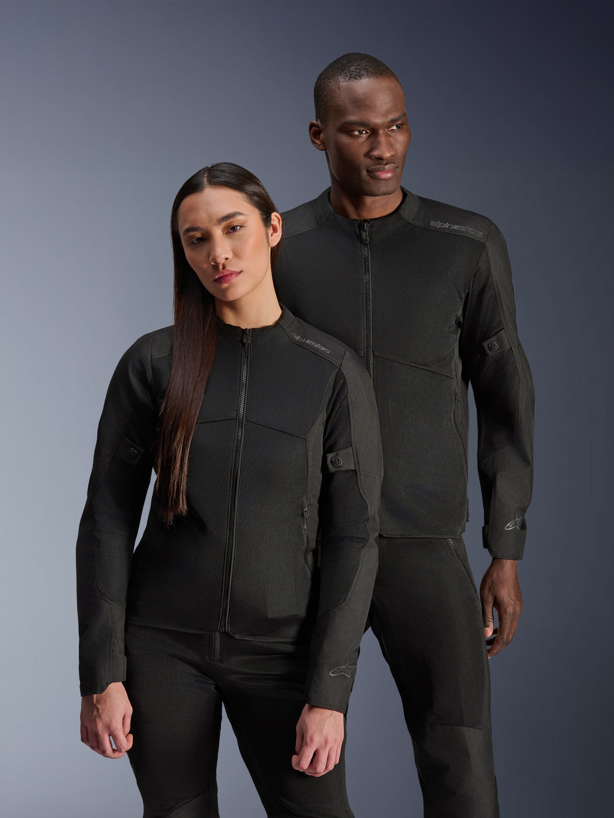Alpinestars Stella C-1 Air Jacket, Black, worn by a male and female model, technical mesh construction for airflow, reflective logos, sleek urban motorcycle riding gear