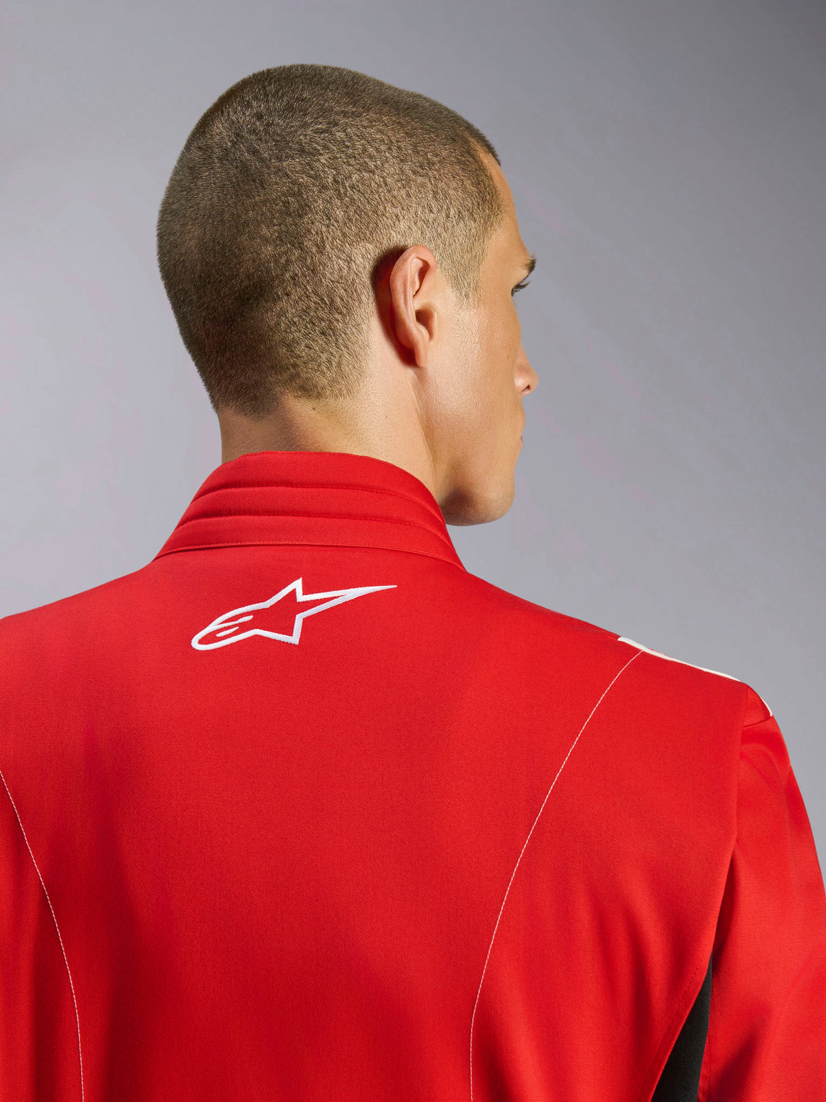 Alpinestars Kart Indoor V2 Suit, Red, close-up of the upper back and neck area showing a white embroidered logo and contrast stitching, ergonomic collar design for karting