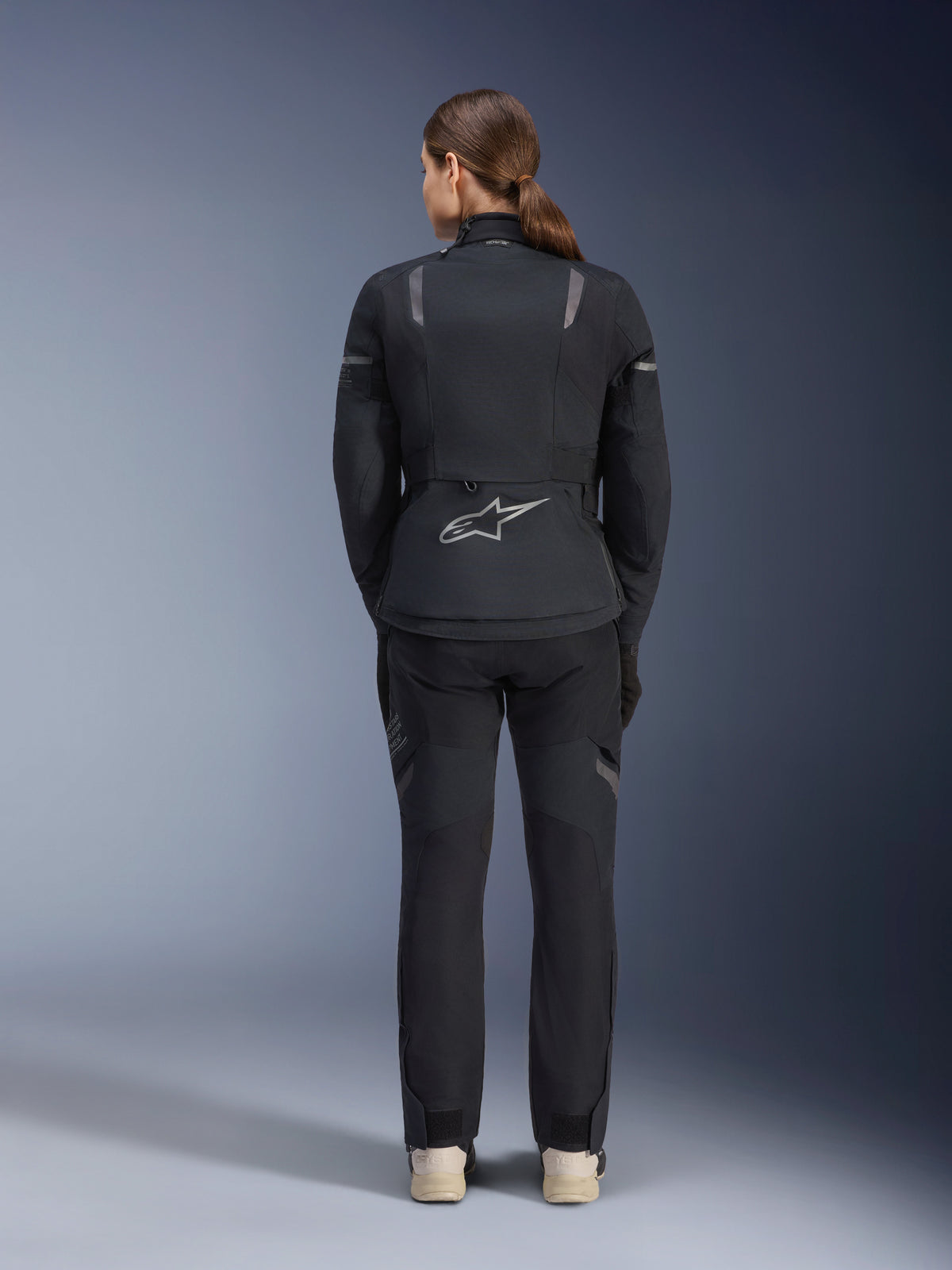 Alpinestars Stella ST-7 2L GORE-TEX Jacket and Pants, Women's Motorcycle Adventure Touring outfit, Black and Dark Gray, back view showing the Astar logo and reflective details, durable waterproof textile construction