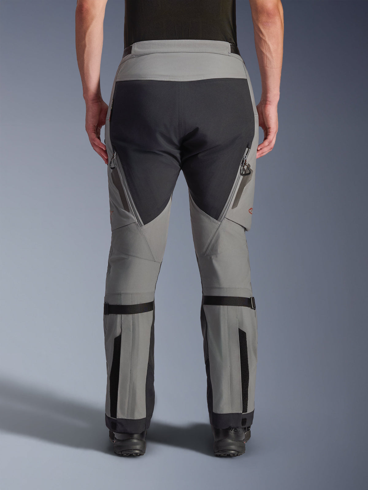 Alpinestars Nazca 3L GORE-TEX PRO Hose, Adventure-Motorradhose, Dunkelgrau und Schwarz, Rückansicht, mit Belüftungsöffnungen mit Reißverschluss an den Oberschenkeln, Wadenweitenverstellern und verstärkten Gesäßpaneelen, entwickelt für extremes Gelände.