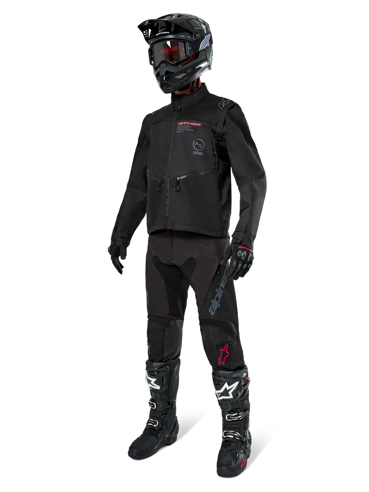 Motocross rider wearing complete racing gear, Alpinestars Pro-Dura Jacket in Black, black pants with grey branding and red accents, black helmet with goggles, and black and white motocross boots, coordinated outfit for enduro and off-road riding