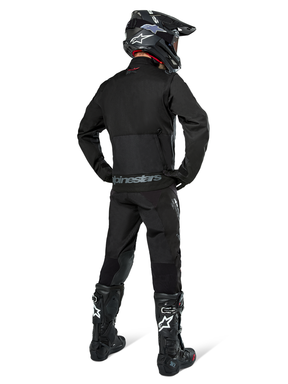 Alpinestars Pro-Dura Jacket, Black Off-road Enduro Jacket, rear view worn with matching pants and black Tech 10 boots, featuring prominent Alpinestars branding on the lower back, rugged textile construction for aggressive trail riding