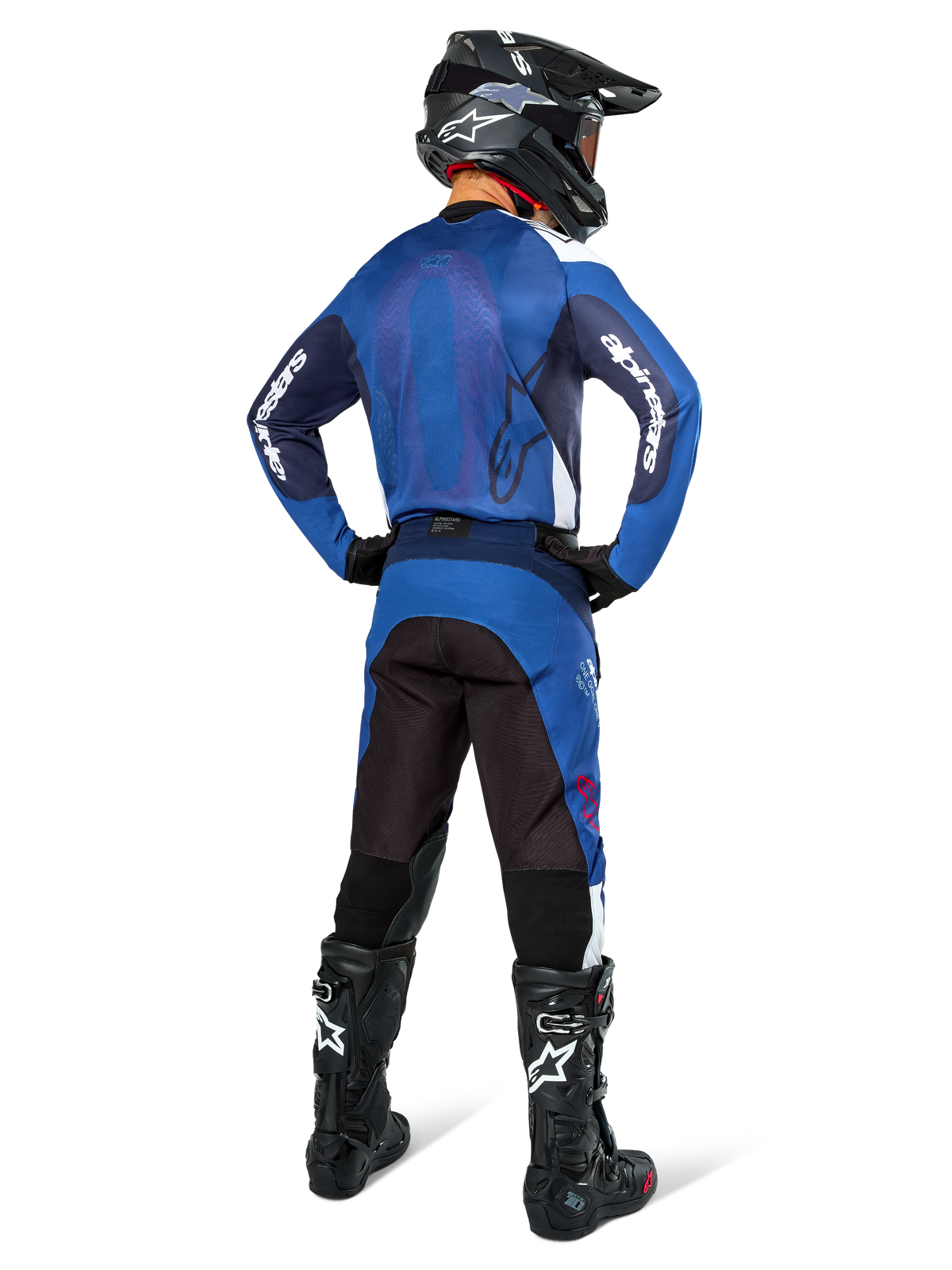 Alpinestars Pro-Dura Hose, Motocross- und Enduro-Hose, Navy Bright Blue White, Rückansicht, getragen mit passendem blauem Trikot, schwarzem Helm und schwarzen Tech Boots, strapazierfähige Konstruktion mit Stretch-Einsätzen für Offroad-Fahrten