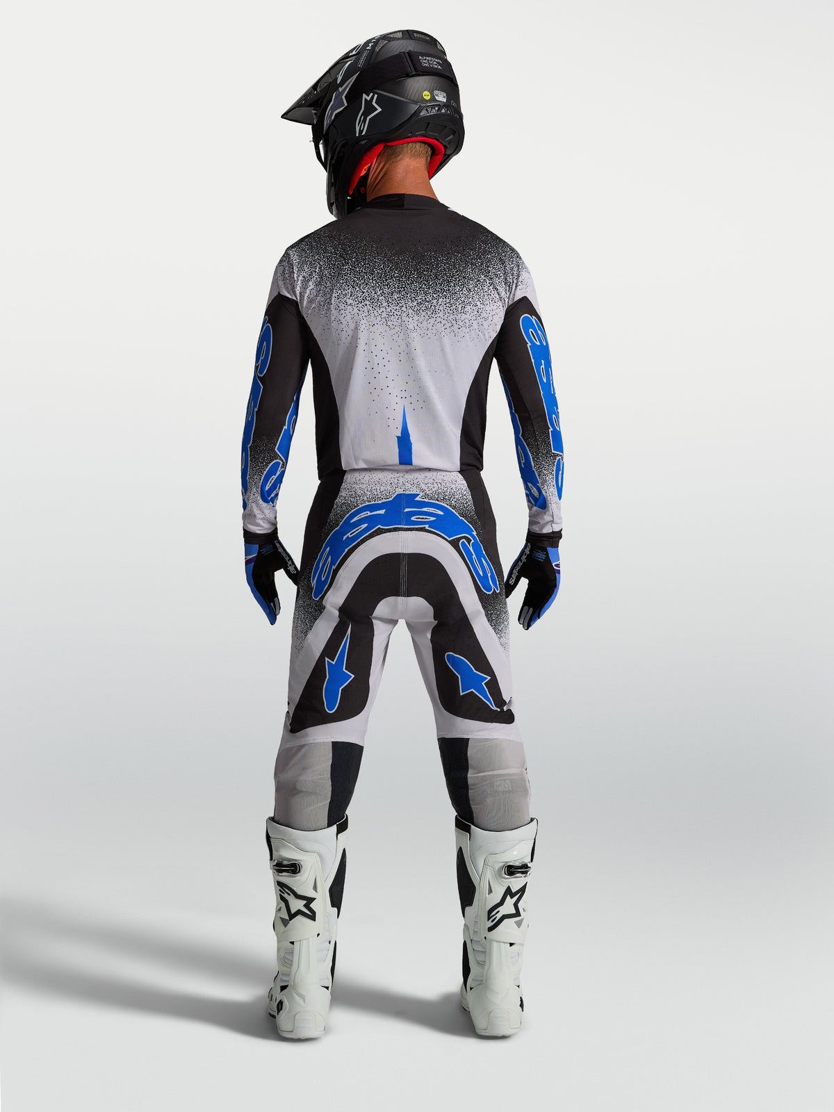 Alpinestars Supertech Hiten AFD Hose, Herren-Motocross-Rennbekleidung in Blau und Weiß, athletische Rückansicht.