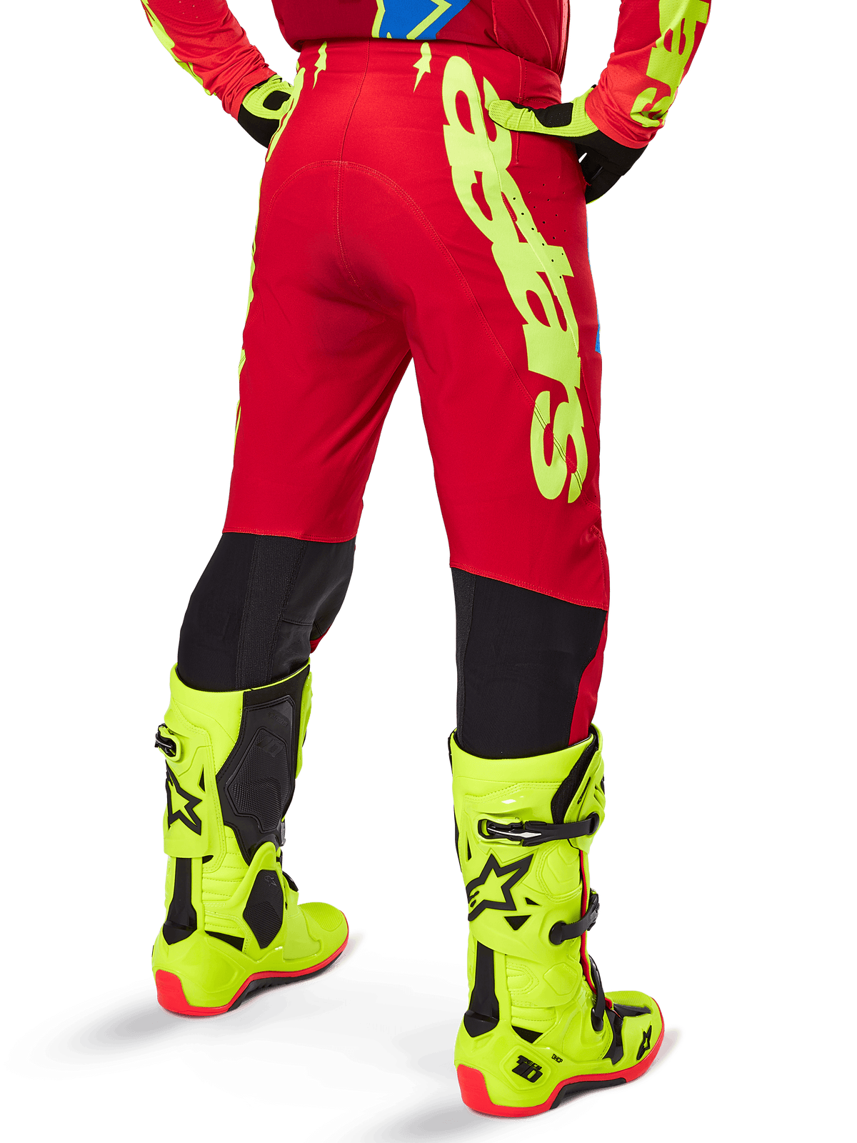 Alpinestars 2025 Supertech Maker Pants, Motocross Pants, Bright Red and Yellow Fluo, rear view, featuring bold yellow branding, black panels behind the knees, worn with matching fluo yellow boots, designed for pro-level off-road performance.