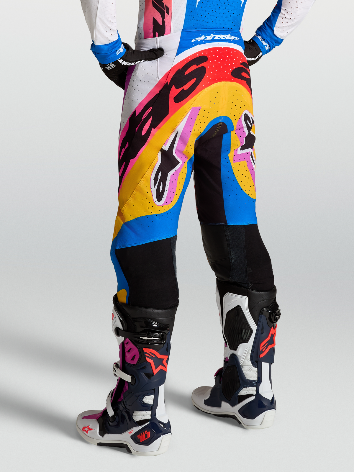 Alpinestars Supertech Dyna Pants in white and blithe blue, premium motocross racing pants on-model with tech-air ready construction and ventilated panels.