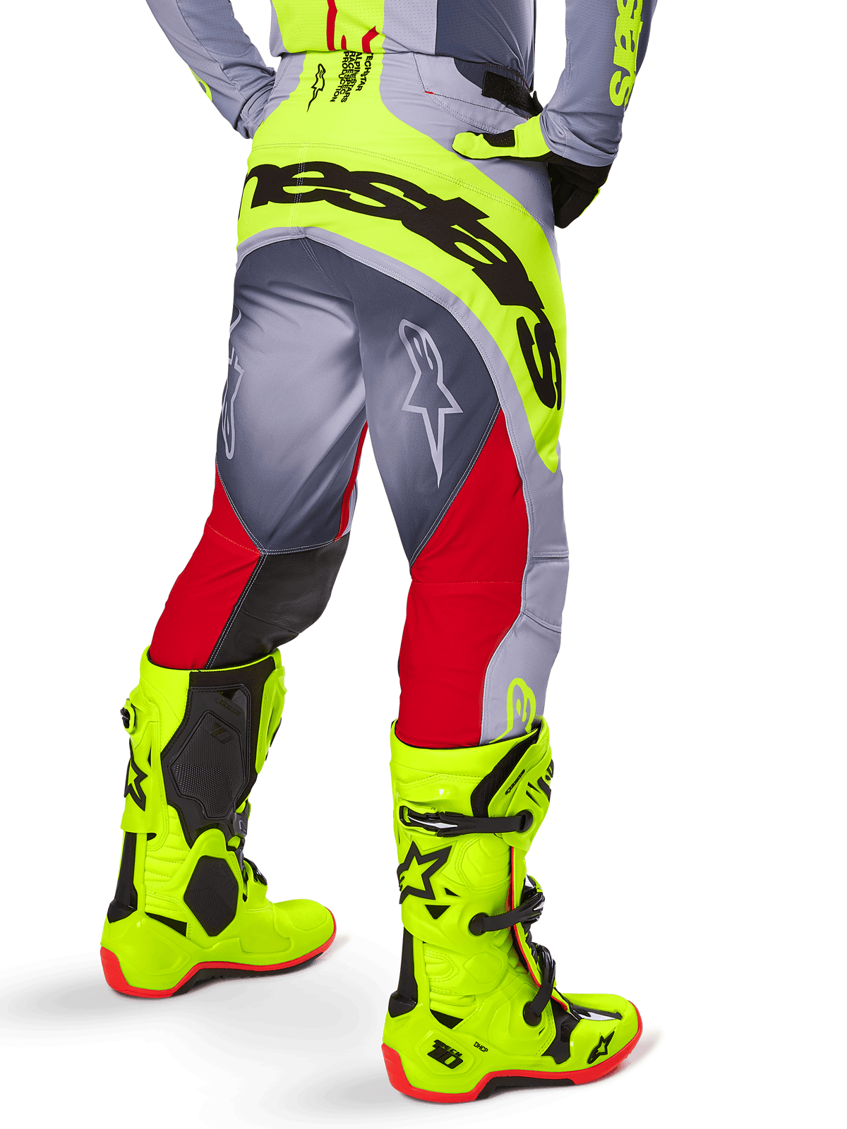 Alpinestars 2025 Techstar Melt Pants, Motocross Pants, Bright Red and Gray with Fluorescent Yellow, back view showing black Alpinestars logo across the seat, paired with matching bright yellow boots, designed for off-road performance