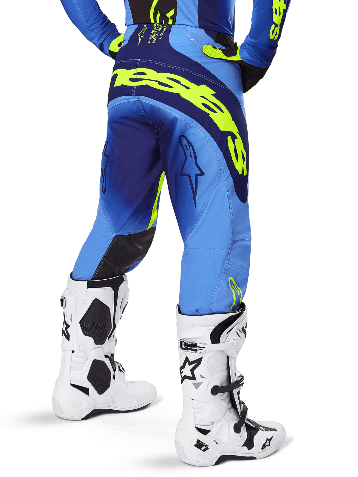 Alpinestars 2025 Techstar Melt Hose, Motocross-Hose, Gelb Fluo Blau, Rückansicht mit großem gelben Branding am Gesäß und dunkelblauen Akzenten, getragen mit weißen Alpinestars Tech 10 Stiefeln und einem passenden Trikot.