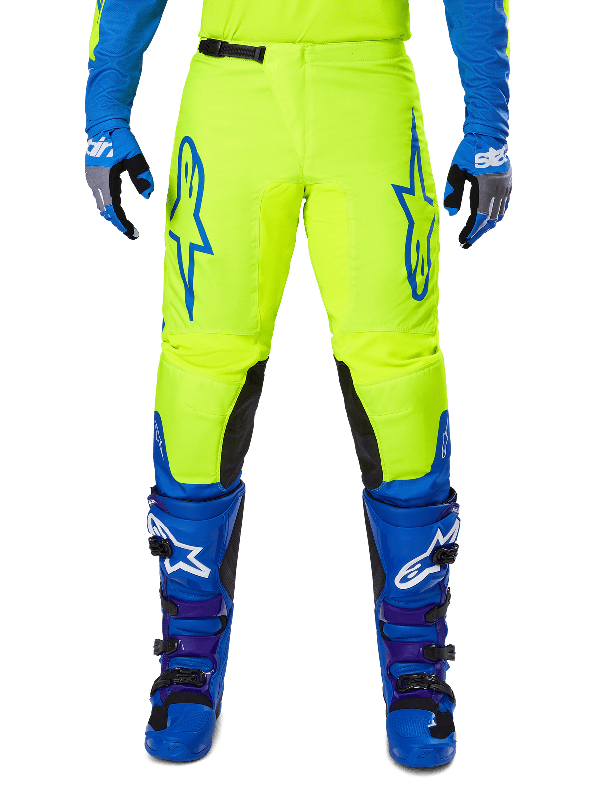 Alpinestars 2025 Fluid Haul Hose, Motocross-Hose, Leuchtendes Gelb und Blau, getragen mit passenden Handschuhen und Stiefeln, schwarze Knieinnenseiten, markantes blaues Branding auf den Oberschenkeln, sportliches ergonomisches Design