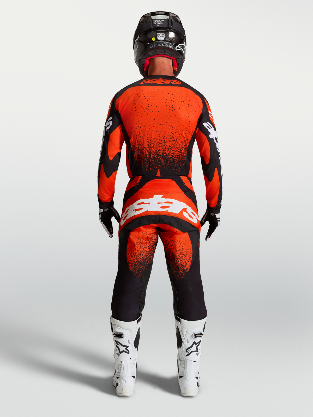 Alpinestars Techstar Swan Pants, Cardinal Red and Black Motocross Gear for Men, rear view on model with white racing boots.