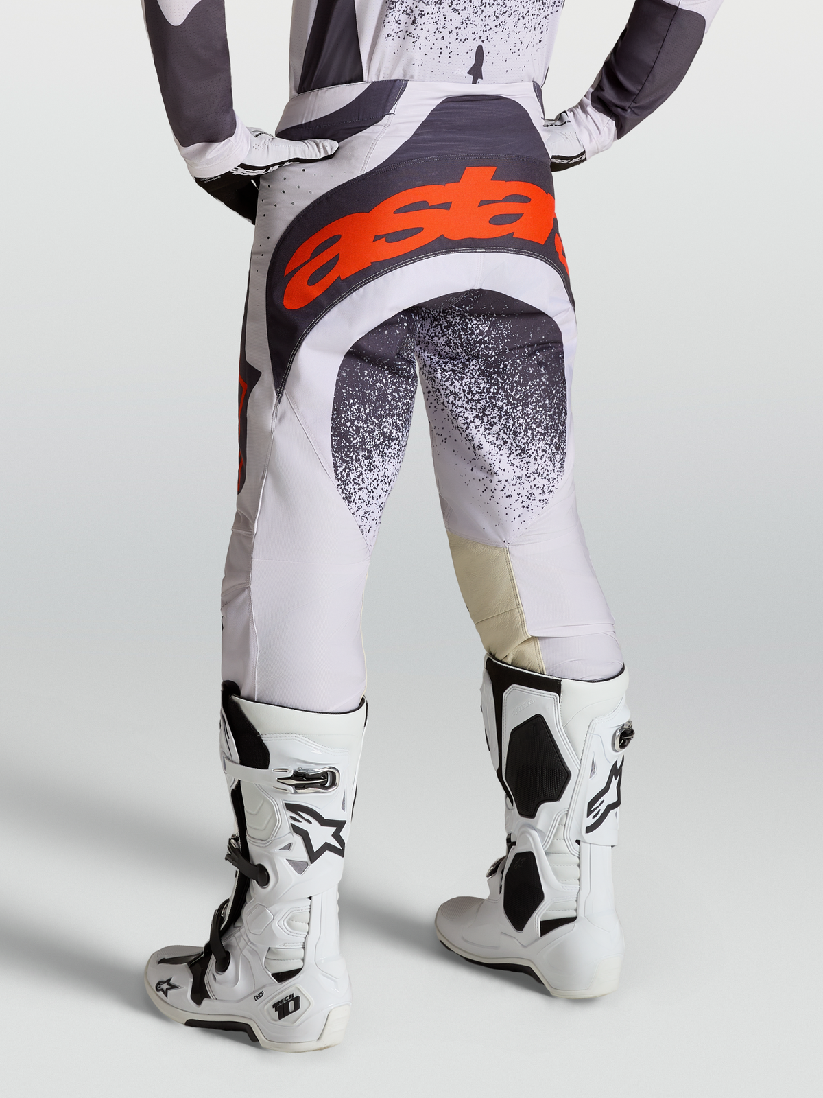 Alpinestars Techstar Swan Pants, Motocross Racing Pants for Men, Light Lilac and Dark Gray, Red Fluo accents, with Tech 10 boots.