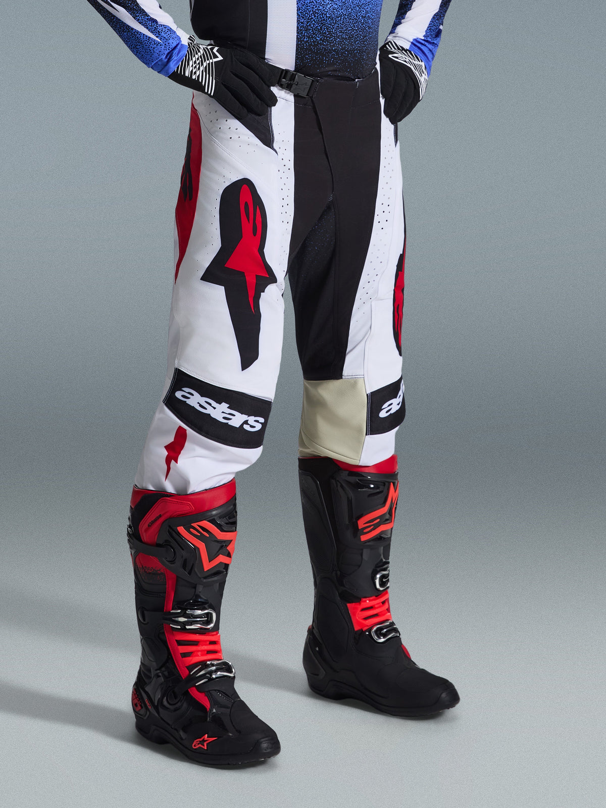Alpinestars 2026 Techstar Knif Pants, Motocross Pants, Black White and Red, worn with black and red motocross boots, featuring bold Astars branding on the thighs, athletic race fit, and durable multi-panel construction for off-road racing.