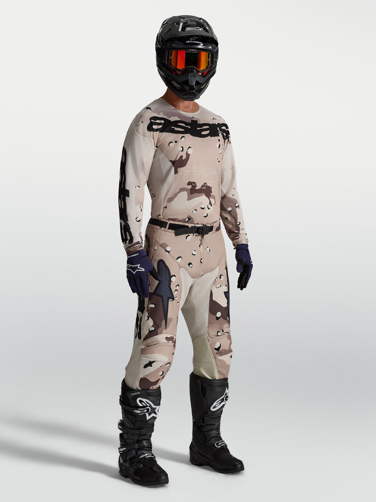 Alpinestars Racer Lone Gear Set, tan and brown camo motocross jersey and pants, with black boots for off-road performance.
