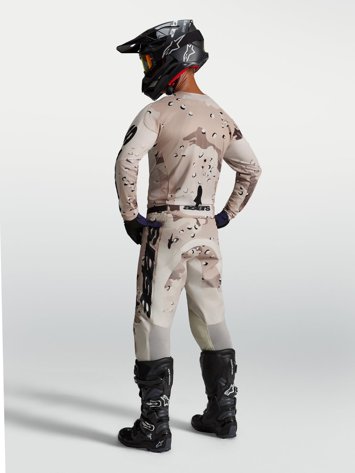 Alpinestars Racer Lone Gear Set, sand camouflage motocross jersey and pants, shown from the back with black boots.
