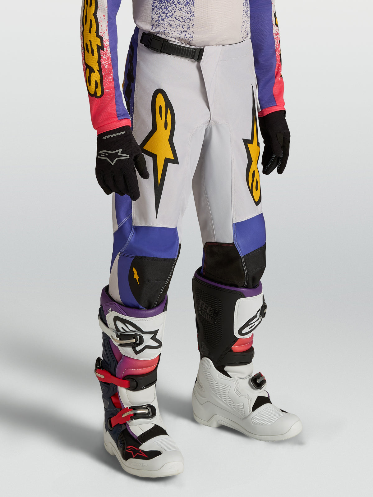 Alpinestars Fluid Drag Jugend-Hose, blau-lila Motocross-Hose mit goldenen Grafiken und ergonomischem Design für Offroad-Fahrten.