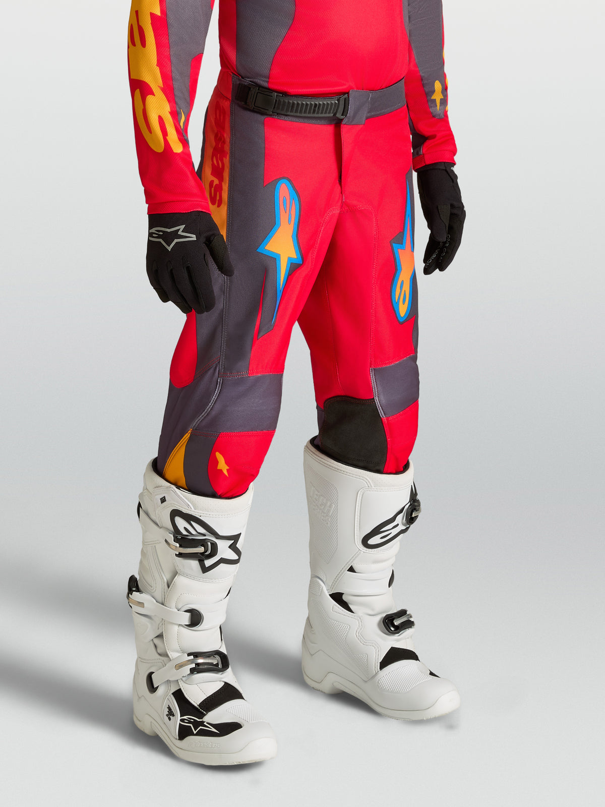 Alpinestars Youth Fluid Hunt Pants, red and gray motocross racing pants for kids, durable textile construction.