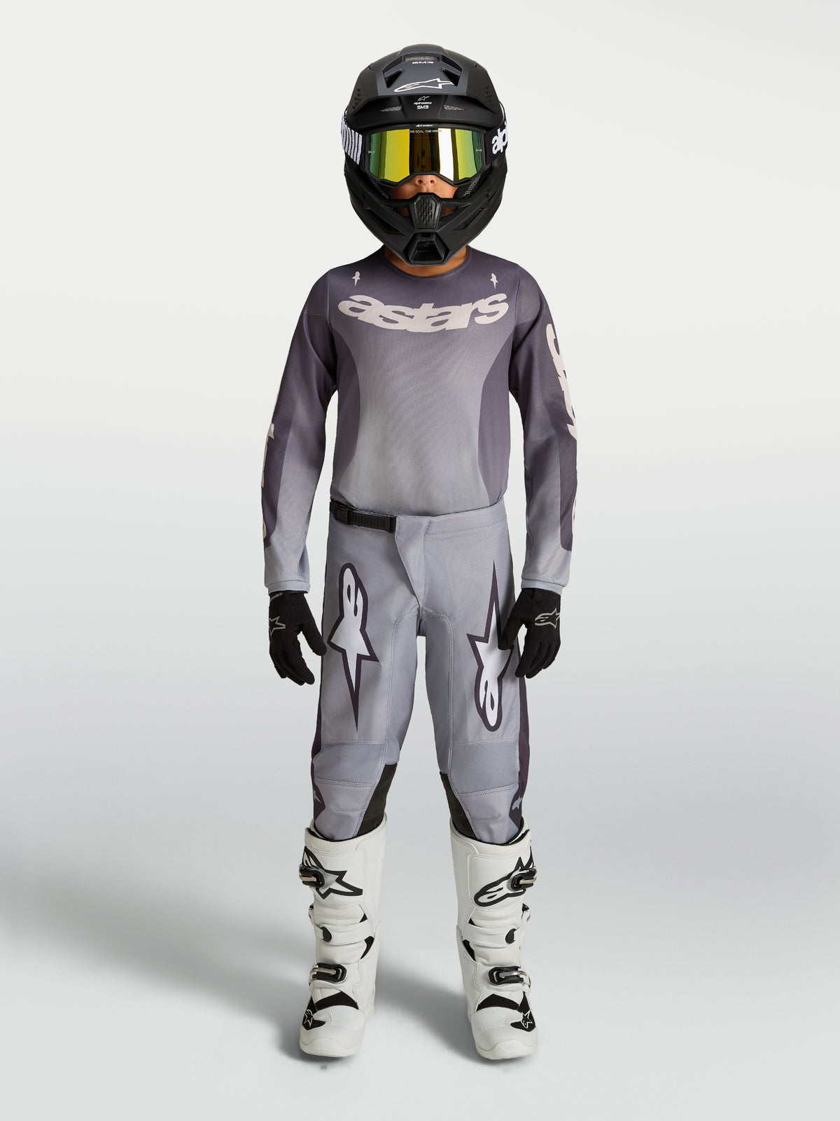 Alpinestars Youth Fluid Amber Pants, Gray and Sand 600D textile motocross pants for youth, shown with matching gear.