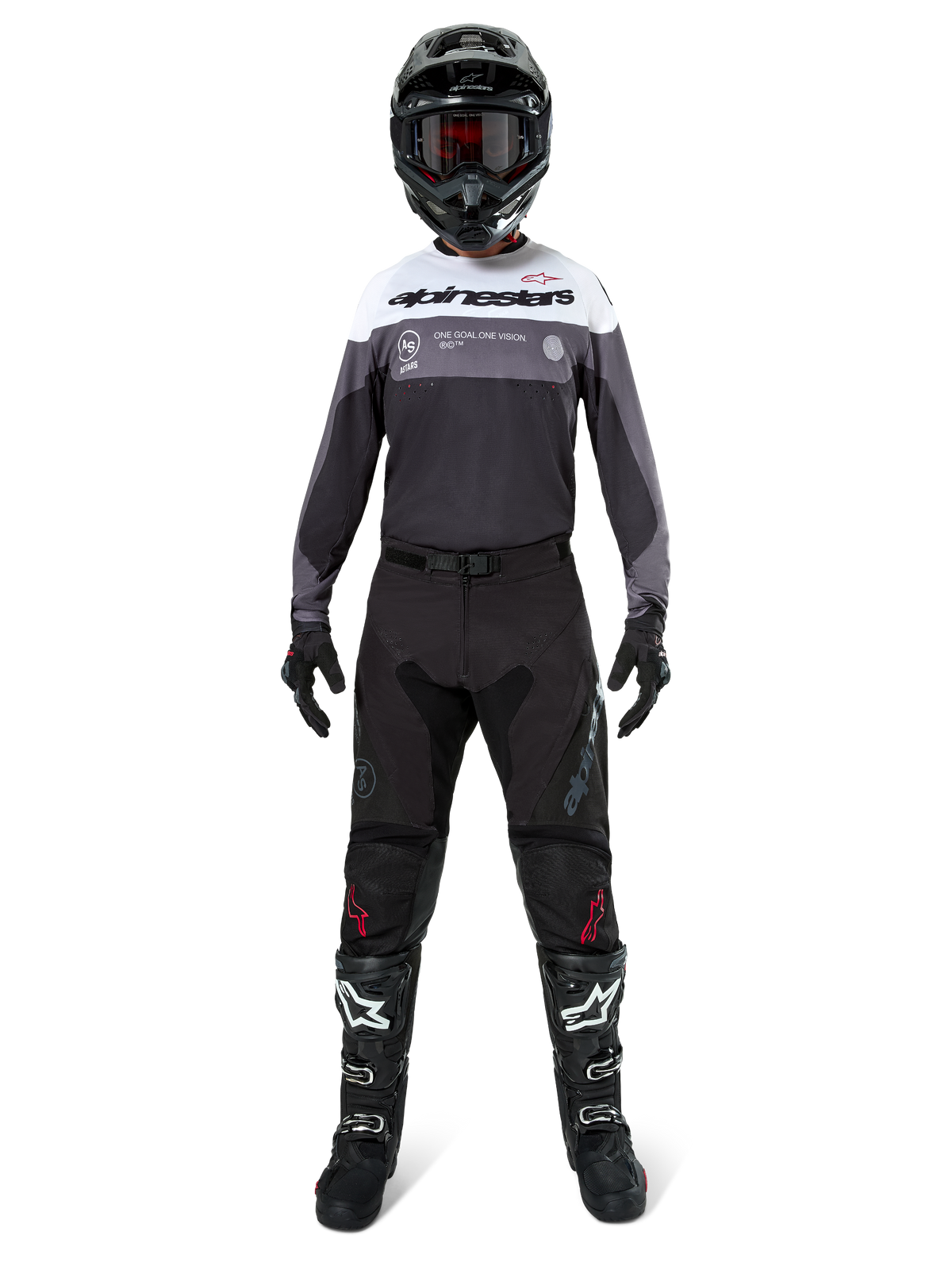 Motocross rider wearing complete racing gear, Pro-Dura Jersey in Black Magnet White with white upper chest and grey accents, paired with black pants, black helmet with dark goggles, white and black boots, and black gloves, coordinated outfit for enduro and off-road racing