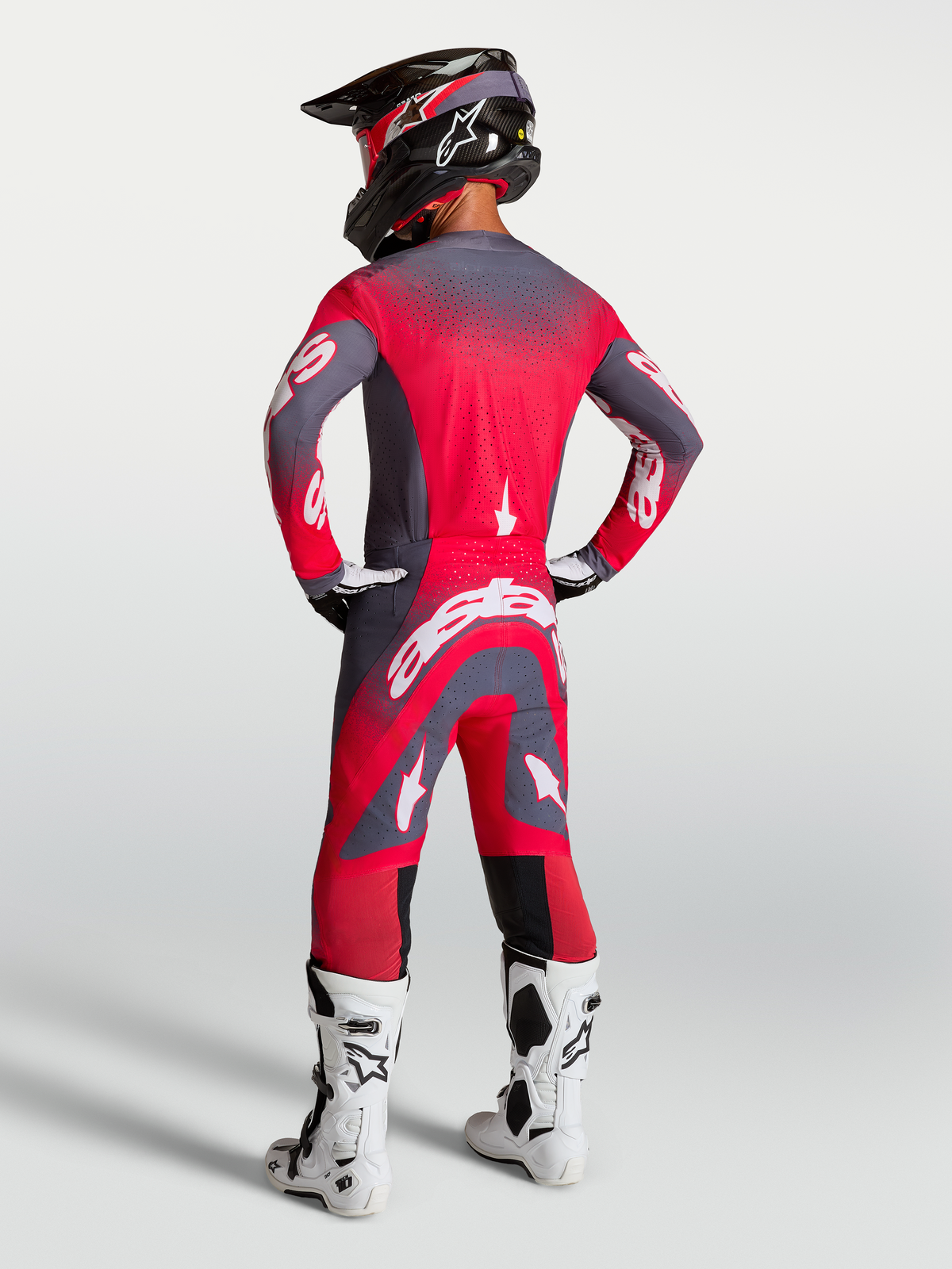 Alpinestars Supertech Hiten AFD Trikot und Gear Set, Motocross-Outfit in Rot Fluo und Grau, Rückansicht am Model.