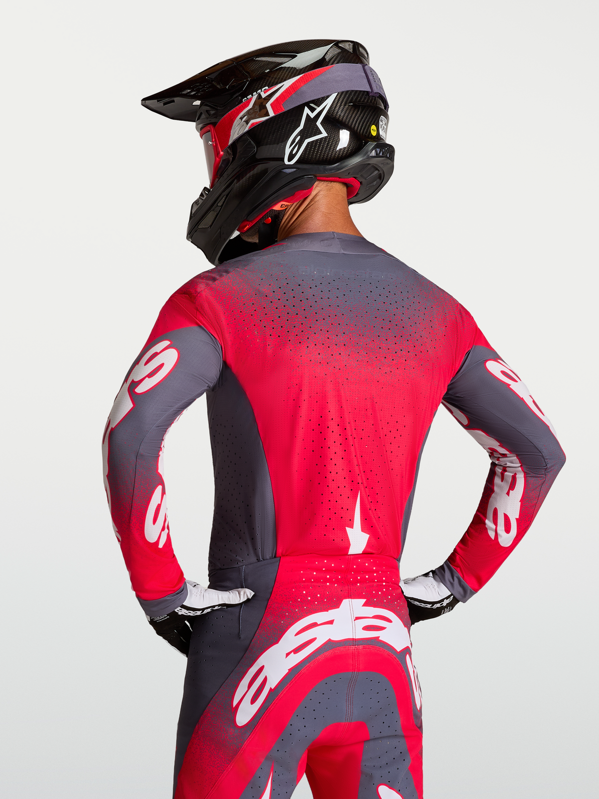 Alpinestars Supertech Hiten AFD Jersey, Motocross Racing Jersey in Graystone and Red Fluo, featuring Stretchnet back ventilation and a professional athletic fit shown on a rider.
