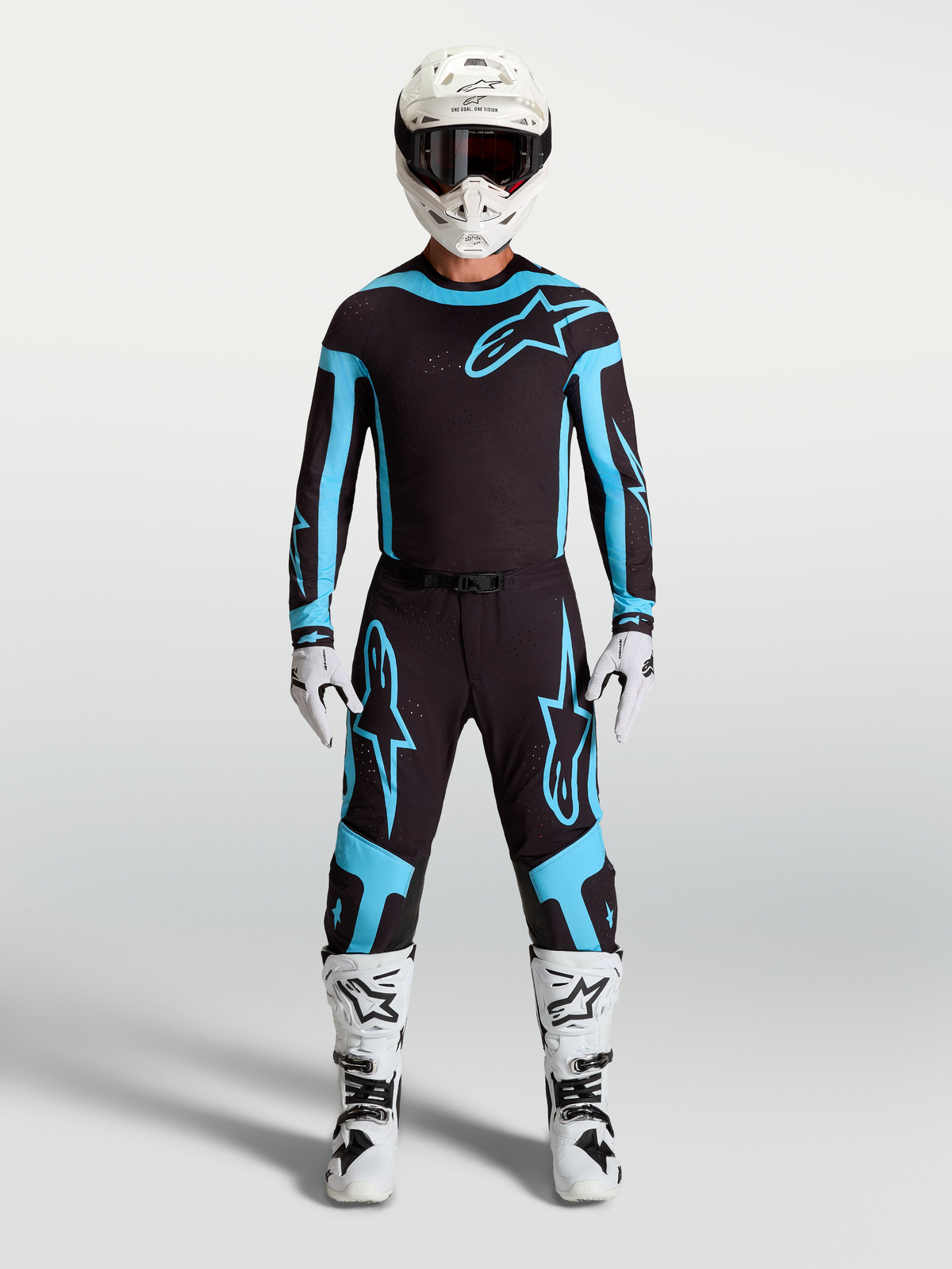 Alpinestars Supertech Vesta Jersey and Gear Set, Men's Motocross Outfit, Black and Turquoise with White Boots and Helmet.