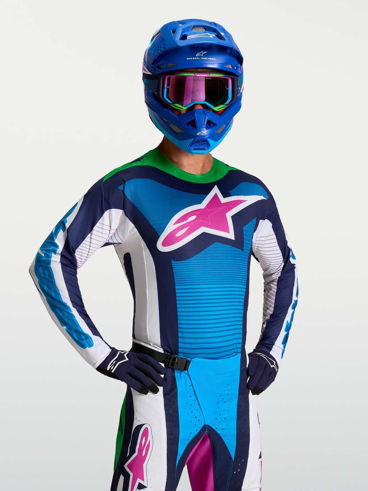 Alpinestars Techstar Maven Trikot, Herren-Motocross-Trikot in Blau und Weiß mit pinkem Stern-Logo und grünem Kragen.