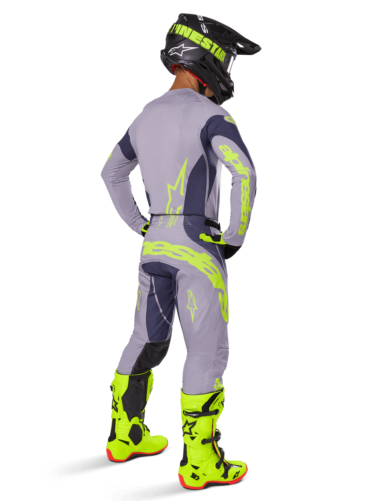 Alpinestars 2025 Techstar Dreem Trikot, Motocross-Trikot, Grau und Dunkelgrau, getragen mit passender Hose und leuchtend neongelben Stiefeln, Rückansicht mit neongelbem Branding und athletischer Passform für Offroad-Rennsport