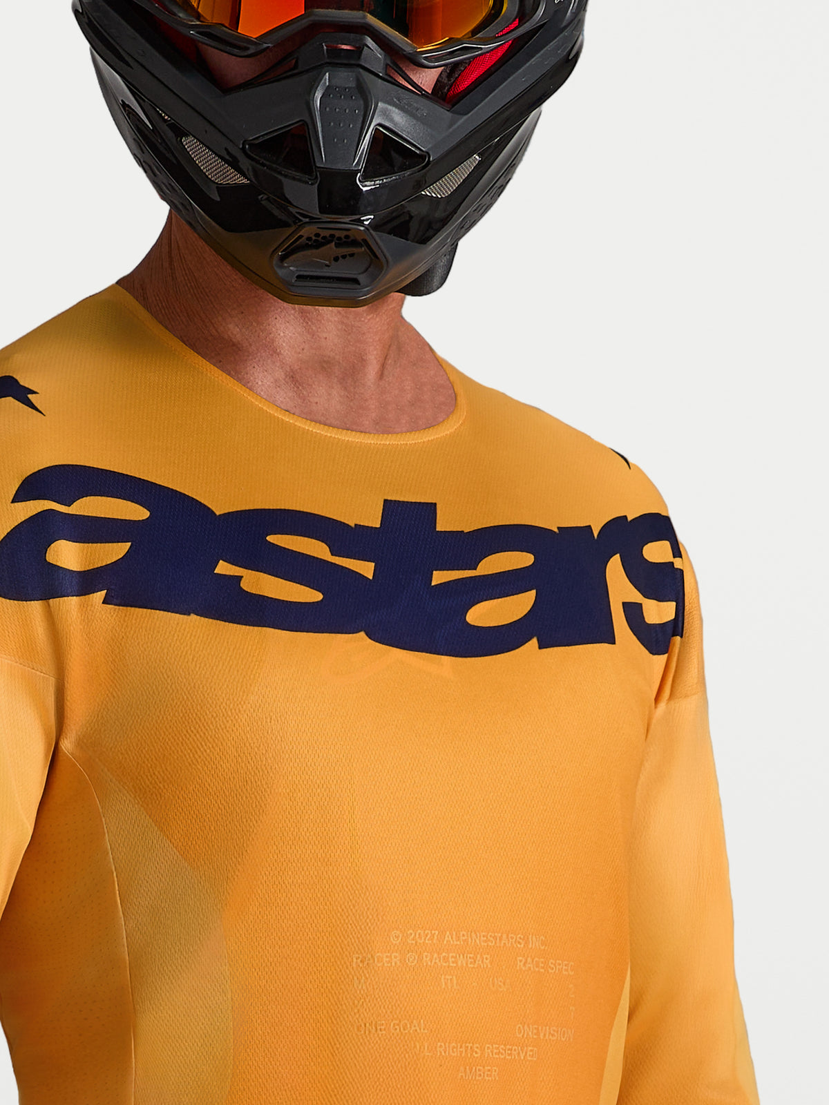 Alpinestars Racer Amber Trikot, orange-dunkelblaues Motocross-Trikot mit feuchtigkeitsableitendem Stoff und Brust-Logo.
