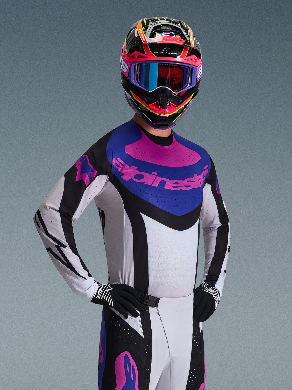 2026 Techstar Knif Jersey, Motocross Jersey, Black Light Gray and Purple, worn by a rider in complete gear, featuring a white chassis with black accents and a blue chest panel with a purple Alpinestars logo, high-performance racing fit for off-road.