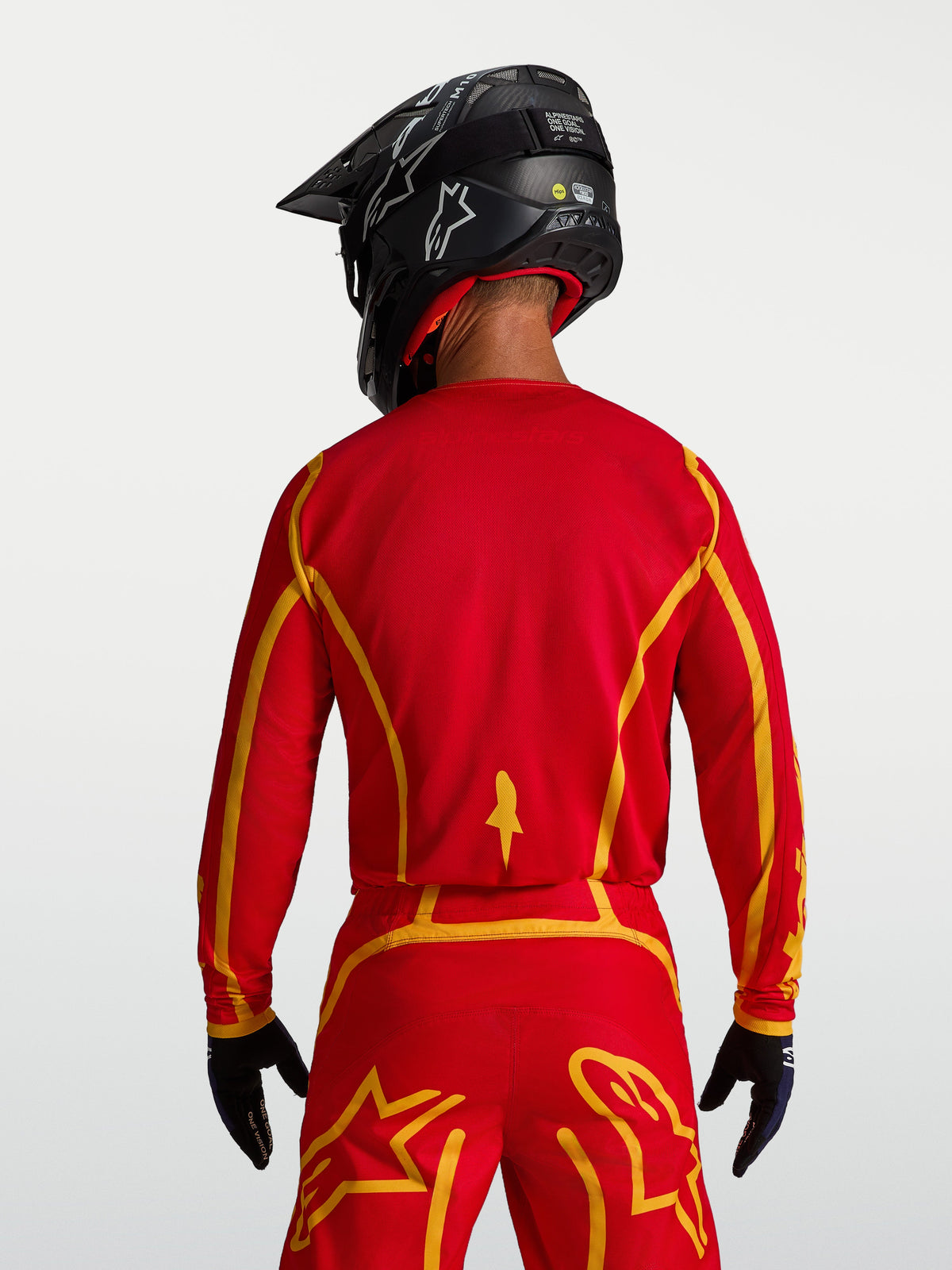 Alpinestars Fluid Apex V2 Jersey, Fire Red and Gold men's motocross gear, rear view with ergonomic cut and breathable fabric.